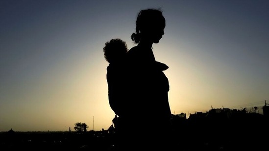 An Ethiopian woman who fled the ongoing fighting in Tigray region, carries her child near the Setit river on the Sudan-Ethiopia border in Hamdayet village in eastern Kassala state, Sudan. (REUTERS) An Ethiopian woman who fled the ongoing fighting in Tigray region, carries her child near the Setit river on the Sudan-Ethiopia border in Hamdayet village in eastern Kassala state, Sudan. (REUTERS)
