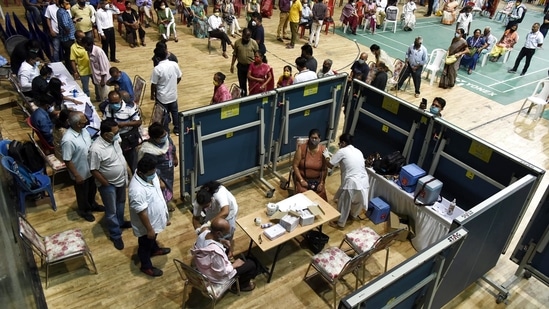People wait for their turn to get the dose of the Covid-19 vaccine at an indoor stadium of RG Baruah Sports Complex in Guwahati on Thursday. (ANI photo) People wait for their turn to get the dose of the Covid-19 vaccine at an indoor stadium of RG Baruah Sports Complex in Guwahati on Thursday. (ANI photo)