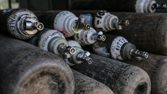 Empty oxygen tanks in an transport vehicle outside a refill station in Navi Mumbai on Thursday. (Bloomberg File Photo ) Empty oxygen tanks in an transport vehicle outside a refill station in Navi Mumbai on Thursday. (Bloomberg File Photo )