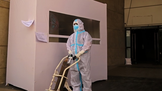 A healthcare worker pushes a trolley holding an oxygen tank at a temporary hospital for Covid-19 patients at a stadium in New Delhi, (Bloomberg) A healthcare worker pushes a trolley holding an oxygen tank at a temporary hospital for Covid-19 patients at a stadium in New Delhi, (Bloomberg)