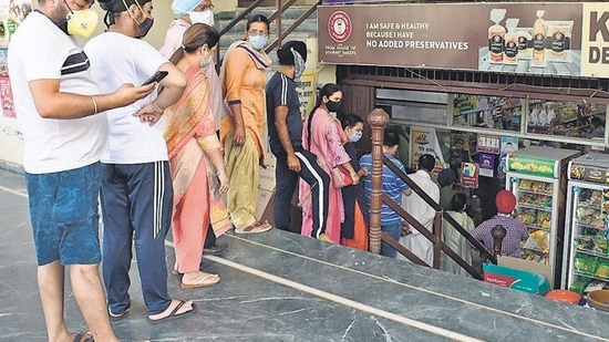 Residents queuing up outside a departmental store to stock up on essentials.&nbsp;(Harsimar Pal Singh/HT File Photo)