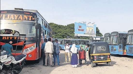 Passengers board a bus at Sangamwadi bus stop in Pune, on Thursday. (SHANKAR NARAYAN/HT)