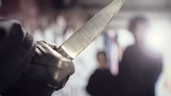 The woman was knifed in the throat, two security sources said.
