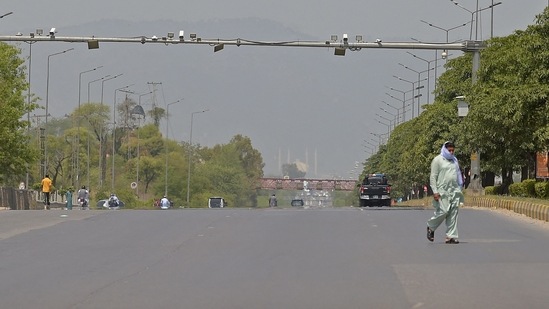 A man walks through a deserted Expressway in Islamabad earlier this month. Pakistan is reeling under the third wave of the deadly coronavirus disease (Covid-19). (AFP)