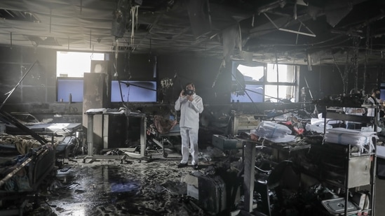 Virar: Maharashtra state Minister Eknath Shinde at the site of the fire at a Covid-19 hospital, where at least 13 patients died, in Virar, Friday, April 23, 2021. (PTI) Virar: Maharashtra state Minister Eknath Shinde at the site of the fire at a Covid-19 hospital, where at least 13 patients died, in Virar, Friday, April 23, 2021. (PTI)