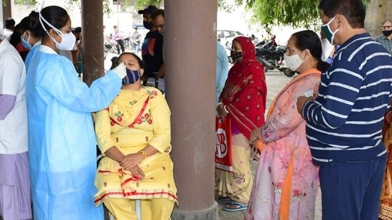 A health worker sampling residents for Covid test A health worker sampling residents for Covid test