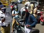 Mumbai Police personnel check vehicles at a police checkpost as only people in essential service are allowed to travel during the lockdown, at Prabhadevi in Mumbai, India.