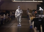 A health worker walks through at a makeshift Covid-19 quarantine facility set up at a banquet hall in New Delhi. A health worker walks through at a makeshift Covid-19 quarantine facility set up at a banquet hall in New Delhi.