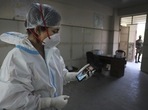Health worker Kavita Sherawat, 30, shows a photograph of her son Parakhshit before proceeding to take samples to test for COVID-19, in New Delhi. Health worker Kavita Sherawat, 30, shows a photograph of her son Parakhshit before proceeding to take samples to test for COVID-19, in New Delhi.