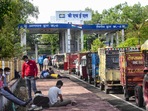 People with their vehicles wait outside BHEL factory to get the oxygen cylinders refilled, during COVID-induced curfew imposed due to surge in coronavirus cases, in Bhopal, Thursday, April 22, 2021. 
