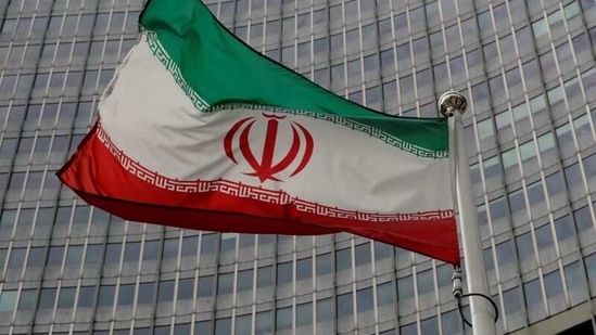 An Iranian flag flutters in front of the International Atomic Energy Agency (IAEA) headquarters in Vienna, Austria.(Reuters)