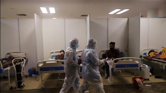 Health workers and patients in a Covid-19 hospital set up inside a stadium in New Delhi, India, on Friday. (Bloomberg) Health workers and patients in a Covid-19 hospital set up inside a stadium in New Delhi, India, on Friday. (Bloomberg)