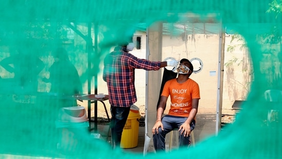 A health worker takes a nasal swab sample from a man to test for Covid-19 in Hyderabad on April 24. The country is testing at the highest rate ever – in the week ending April 22, India on average, tested 1.56 million samples every day. And this number is increasing: on April 23, the country set a single-day testing record with 1.75 million samples tested.(Mahesh Kumar A. / AP)
