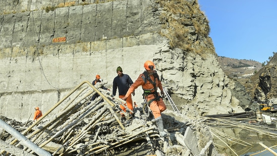 In this file photo from February, NDRF personnel are seen carrying out rescue and restoration work at damaged Tapovan barrage, weeks after the glacier burst at Joshimath which triggered a massive flash flood on Feb. 7, in Chamoli district of Uttarakhand. (PTI Photo)