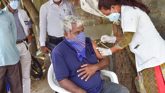 A medic administers the COVID-19 vaccine amid surge in coronavirus cases in Bengaluru. (PTI Photo) A medic administers the COVID-19 vaccine amid surge in coronavirus cases in Bengaluru. (PTI Photo)