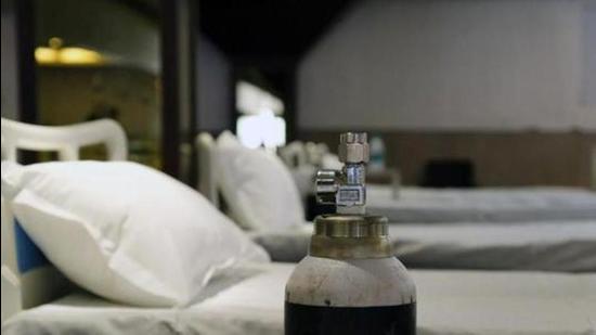 File photo: An oxygen cylinder sits next to a bed in a makeshift ward at an emergency Covid-19 care center. (Bloomberg) File photo: An oxygen cylinder sits next to a bed in a makeshift ward at an emergency Covid-19 care center. (Bloomberg)