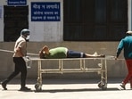 Relatives move a Covid-19 patient on a stretcher at GTB Hospital, in New Delhi, on April 24. An unprecedented spike in Covid-19 cases in Delhi in its fourth wave – the worst so far – pushed the number of total infections in the national capital past the one million mark on April 24.(Amal KS / HT Photo)