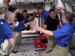 Crew 2 member JAXA astronaut Akihiko Hoshide of Japan is embraced by his compatriot Crew 1 member JAXA astronaut Soichi Noguchi as he and ESA astronaut Thomas Pesquet of France are welcomed as they arrive aboard the International Space Station, after docking SpaceX's Crew Dragon capsule obiting the earth.(Reuters)