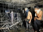 People look on at Ibn Khatib hospital after a fire caused by an oxygen tank explosion in Baghdad, Iraq, April 25, 2021. 