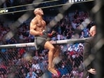 Kamaru Usman celebrates his win atop the octagon fence after a UFC 261 mixed martial arts bout against Jorge Masvidal early Sunday. Kamaru Usman celebrates his win atop the octagon fence after a UFC 261 mixed martial arts bout against Jorge Masvidal early Sunday.