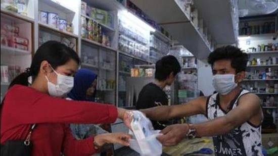 File photo: A girl buys surgical masks in Imphal, capital of the northeastern Indian state of Manipur. (AP) File photo: A girl buys surgical masks in Imphal, capital of the northeastern Indian state of Manipur. (AP)