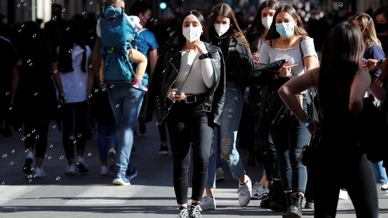 People walk down Via del Corso street amid the coronavirus disease (Covid-19) pandemic in Rome, Italy, (Reuters)