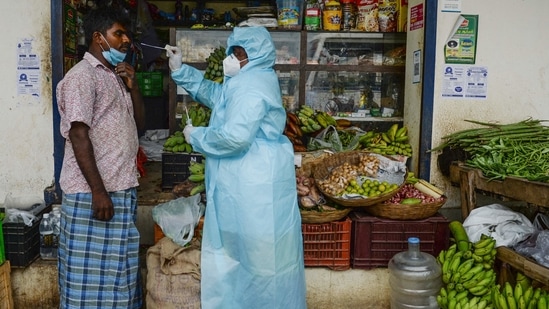 A health worker taking a swab sample from a shopkeeper for a RT-PCR Covid-19 test in Chennai. (Arun Sankar / AFP) A health worker taking a swab sample from a shopkeeper for a RT-PCR Covid-19 test in Chennai. (Arun Sankar / AFP)