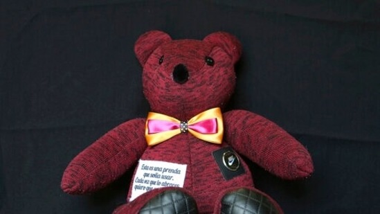 A teddy bear made with pieces of clothing that were worn by a Covid-19 victim, sits in the workshop of seamstress Irma de la Parra, in Mexico City. (AP) A teddy bear made with pieces of clothing that were worn by a Covid-19 victim, sits in the workshop of seamstress Irma de la Parra, in Mexico City. (AP)