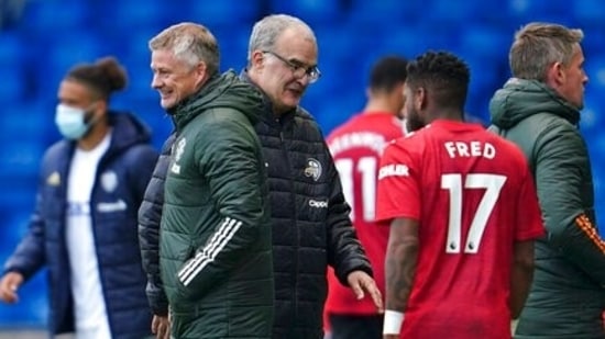 Leeds United's head coach Marcelo Bielsa, center, and Manchester United's manager Ole Gunnar Solskjaer greet each other.(AP)