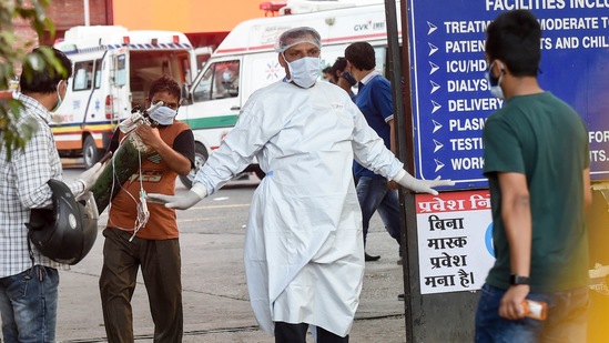 A medical professional gestures outside LNJP Hospital, in New Delhi, on April 24. In Delhi, there are 93,080 active Covid-19 cases, taking the total Covid-19 tally of the city to 1,004,782 as of April 24, HT reported.(Manvender Vashist / PTI)