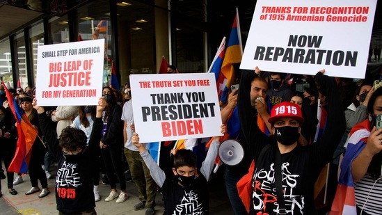 People hold "Thank You President Biden" signs as they protest outside of the Turkish Consulate on the anniversary of the Armenian genocide in a demonstration organized by the Armenian Youth Federation (AYF) in Beverly Hills, California.(AFP)
