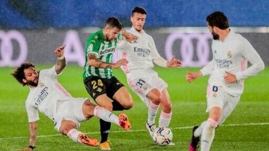 Real Madrid's Marcelo, left, vies for the ball with Betis' Aitor Ruiba. (AP)