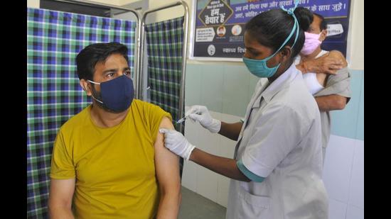 A resident getting Covid vaccine at the Sector-45 Civil Hospital in Chandigarh on Sunday. (Keshav Singh/HT) A resident getting Covid vaccine at the Sector-45 Civil Hospital in Chandigarh on Sunday. (Keshav Singh/HT)