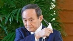 Japanese Prime Minister Yoshihide Suga takes off his face mask before speaking to reporters at his office in Tokyo.(AP) Japanese Prime Minister Yoshihide Suga takes off his face mask before speaking to reporters at his office in Tokyo.(AP)