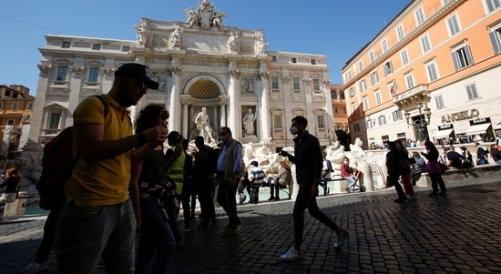 People walk past the Trevi Fountain amid the coronavirus disease (COVID-19) pandemic in Rome, Italy. (REUTERS)
