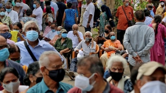 People wearing protective face masks wait to receive a vaccine for the coronavirus disease (Covid-19) at a vaccination centre in Mumbai, India, April 26, 2021. (Reuters)