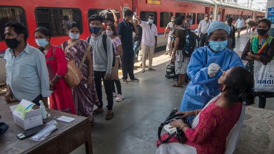 Healthcare worker collects swab sample of the passengers at Dadar station in Mumbai. (Pratik Chorge/HT file photo)