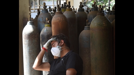A relative of COVID-19 patient waits to get a refill of the cylinder with medical oxygen, New Delhi, April 25, 2021 (PTI) A relative of COVID-19 patient waits to get a refill of the cylinder with medical oxygen, New Delhi, April 25, 2021 (PTI)