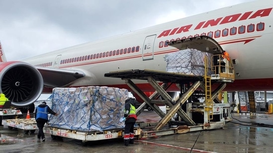 Cargo handlers load oxygen concentrators inside a Delhi-bound Air India at John F. Kennedy International Airport in the United States on Monday (ANI)