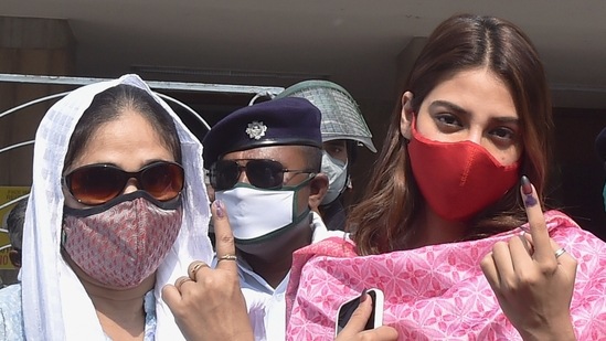 Kolkata: TMC MP Nusrat Jahan (R) with her mother shows her finger marked with indelible ink after casting her vote during the 7th phase of the West Bengal State Assembly polls, at a polling station, in Kolkata, Monday, April 26, 2021. (PTI Photo/Swapan Mahapatra)