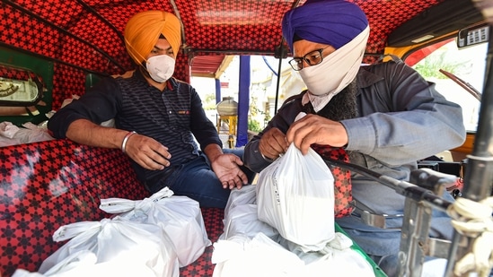 Meals being distributed at the Bangla Sahib Gurdwara, Delhi Sikh Gurdwara Management Committee (DSGMC) is providing cooked meals to Covid-19 patients quarantined at home, in New Delhi, Monday, April 26, 2021. (PTI)