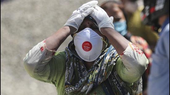 A relative of a person who died of Covid-19 at a crematorium in Jammu. (AP) A relative of a person who died of Covid-19 at a crematorium in Jammu. (AP)
