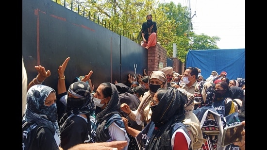 Members of the Punjab Anganwadi Mulazam Union during a protest in front of the Sangrur deputy commissioner’s office on Monday.