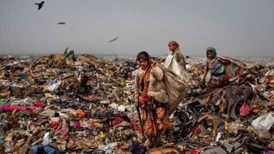 Trash pickers look for recyclable waste at the Bhalswa landfill on the outskirts of New Delhi, India.(AP) Trash pickers look for recyclable waste at the Bhalswa landfill on the outskirts of New Delhi, India.(AP)