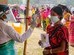 A health worker sanitises voters as they wait in queues to cast votes at a polling station during the 7th phase of West Bengal Assembly elections at a village near Balurghat in South Dinajpur district, Monday, April 26, 2021. (PTI) A health worker sanitises voters as they wait in queues to cast votes at a polling station during the 7th phase of West Bengal Assembly elections at a village near Balurghat in South Dinajpur district, Monday, April 26, 2021. (PTI)
