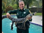 The image shows Deputy Heather Harris with the alligator.