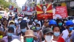 Manifestantes anti-golpe exibem imagens da líder deposta Aung San Suu Kyi enquanto se reúnem em Yangon, Mianmar. (Foto de arquivo da AP)