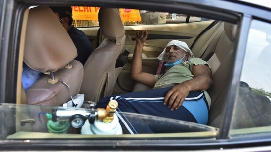 A Covid-19 patient on oxygen support waits in car outside the Lok Nayak Jai Prakash (LNJP) hospital in New Delhi, India, on Monday, April 26, 2021. (Photo by Raj K Raj/ Hindustan Times)