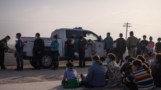 A US Border Patrol agent processes asylum-seeking unaccompanied minors as family units sit on the sideline, (Reuters File Photo) 