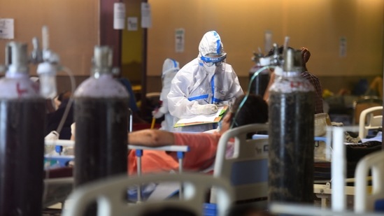 Medical staff in PPE attending to a person in the temporary Covid-19 care centre attached to LNJP Hospital in New Delhi.(Raj K Raj / HT Photo) Medical staff in PPE attending to a person in the temporary Covid-19 care centre attached to LNJP Hospital in New Delhi.